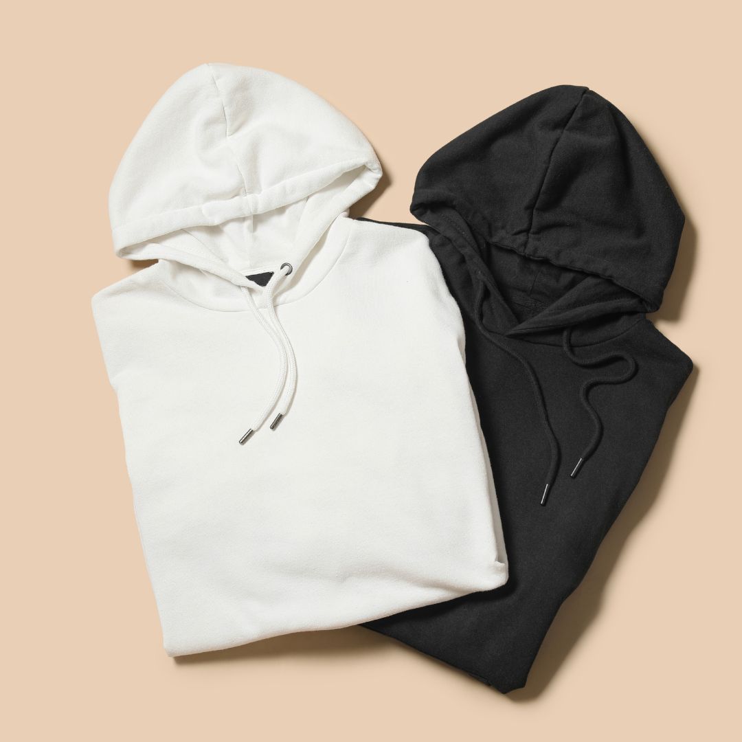 Folded black and white T-shirts stacked together.