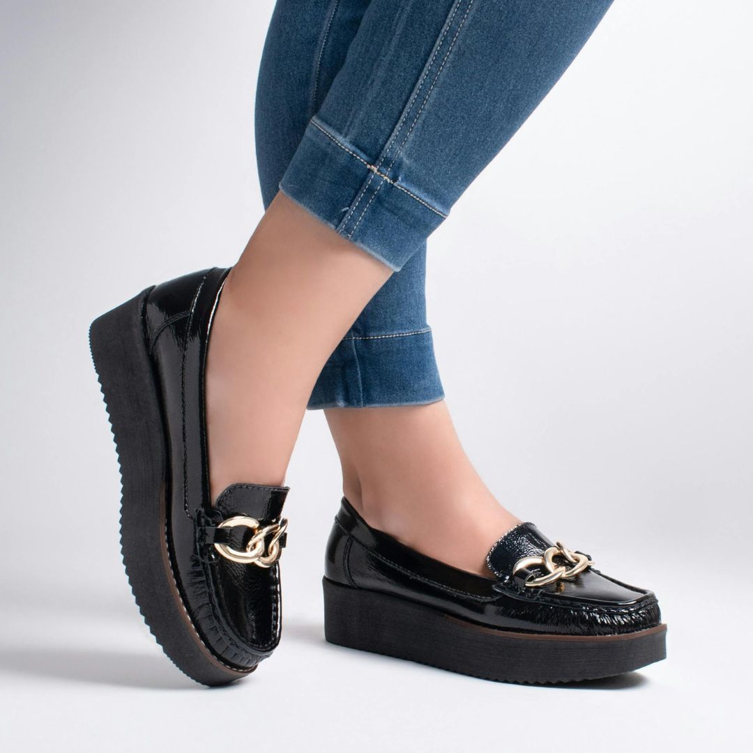 Black loafers worn with cuffed jeans.