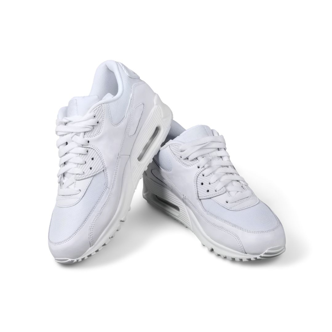 White sneakers photographed at an angle on a white background.