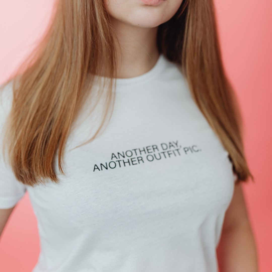 Close-up of a white T-shirt with a script logo.
